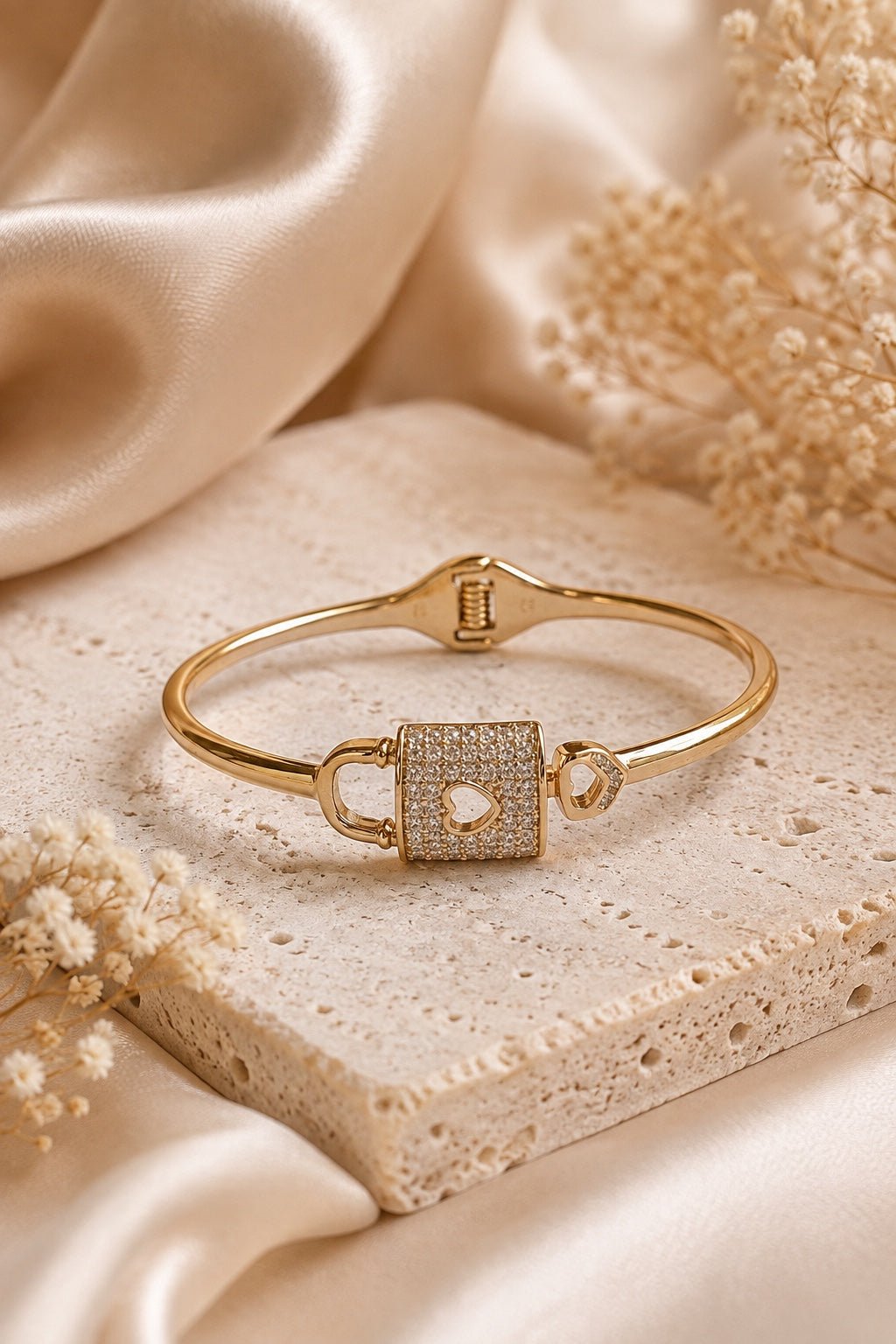 18k gold plated solid bracelet with a lock and heart design on a light luxury background