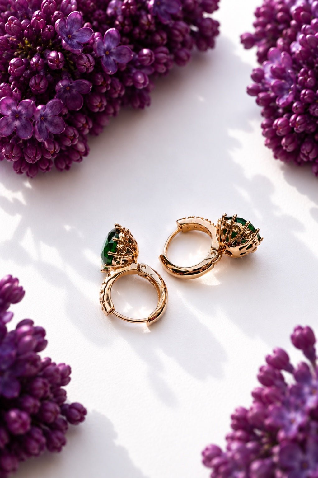 18k gold plated earrings with green cubic zirconia between purple lilacs