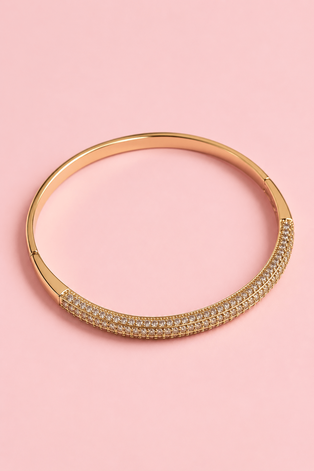 Gold-plated bangle bracelet with embedded zircons