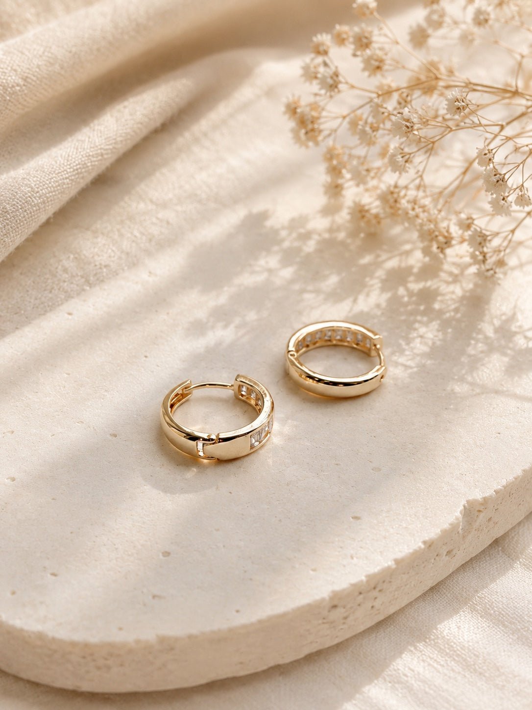 Marta 18k gold-plated moisture-resistant hoop earrings with square zirconias on a light background