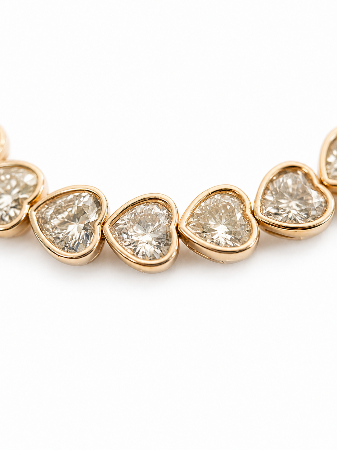 Close-up of a gold-plated bracelet with crystal hearts