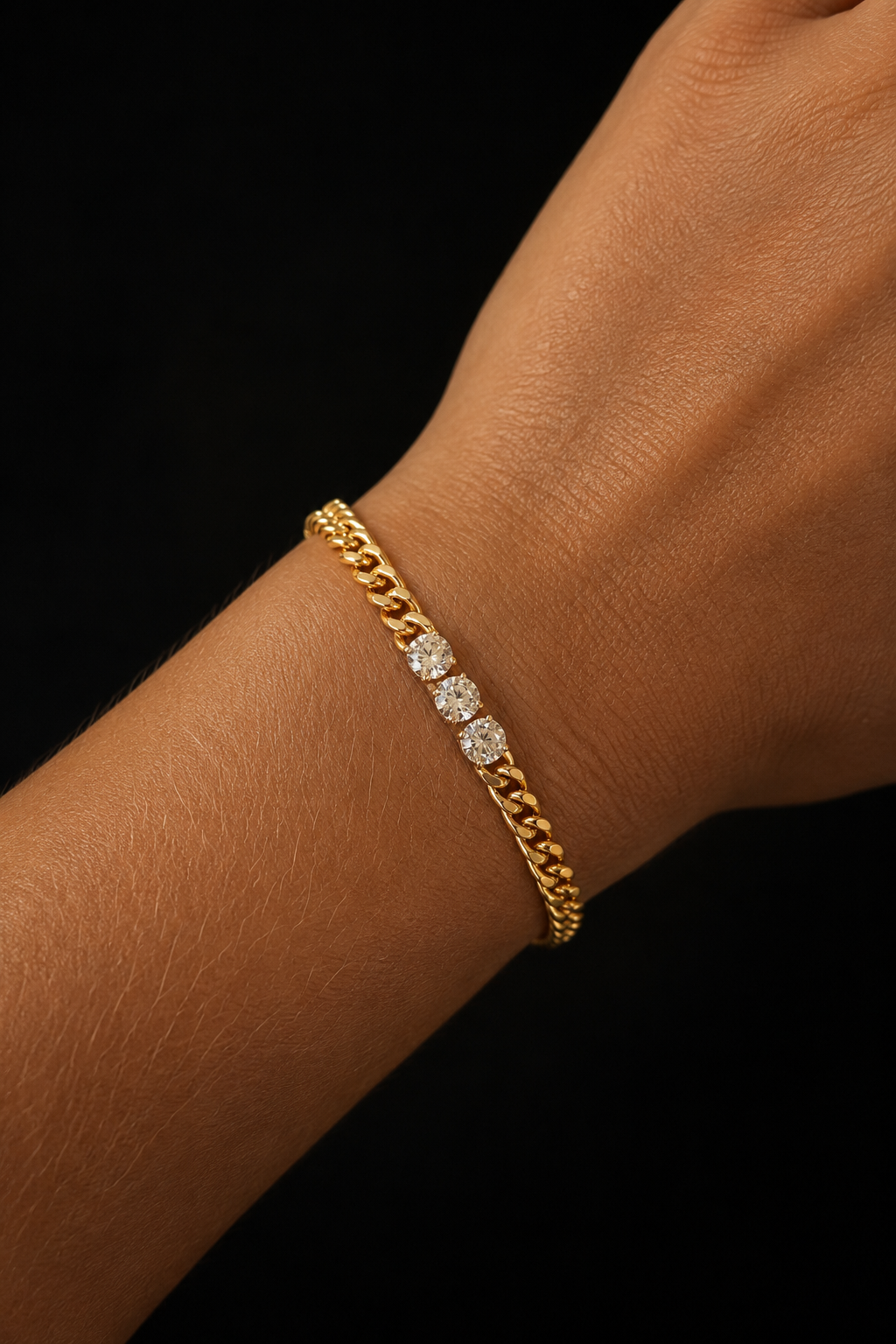 18k gold plated chain bracelet with three clear cubic zirconias on the arm