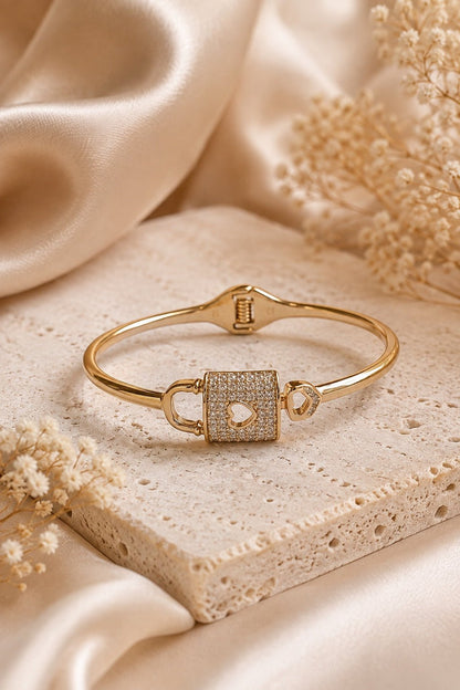 18k gold plated solid bracelet with a lock and heart design on a light luxury background
