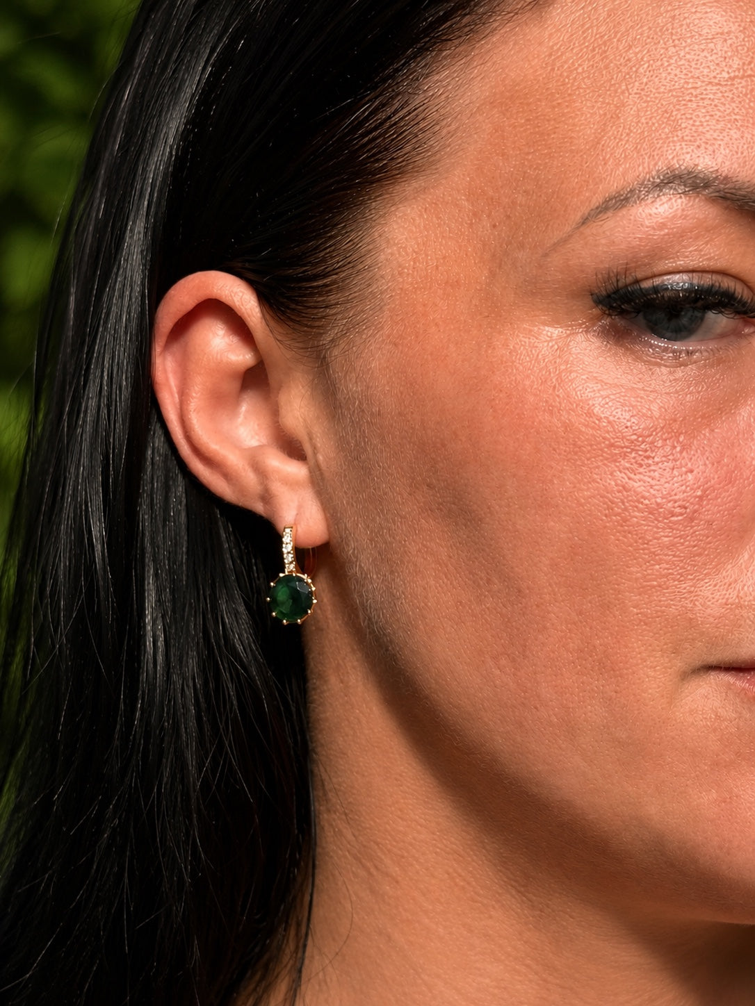 18k gold-plated earrings with green zirconia on the ear
