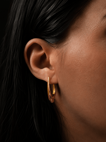 18k gold-plated elongated earring in the model's ear