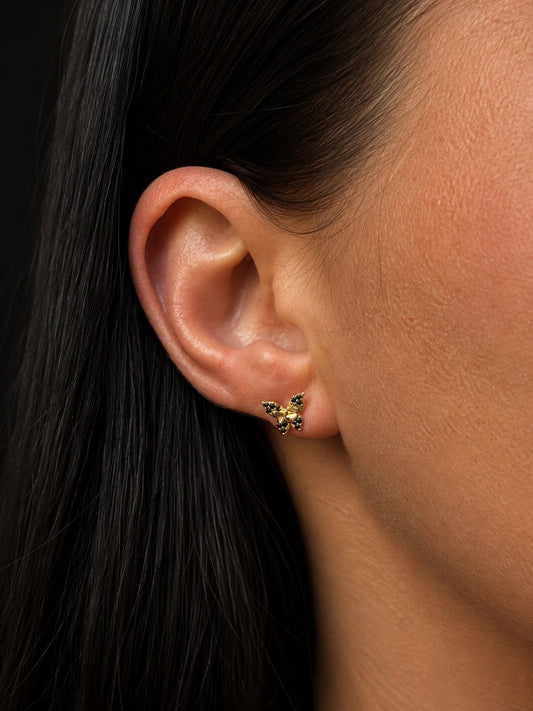 18K gold plated butterfly stud earrings with black cubic zirconias on the ear