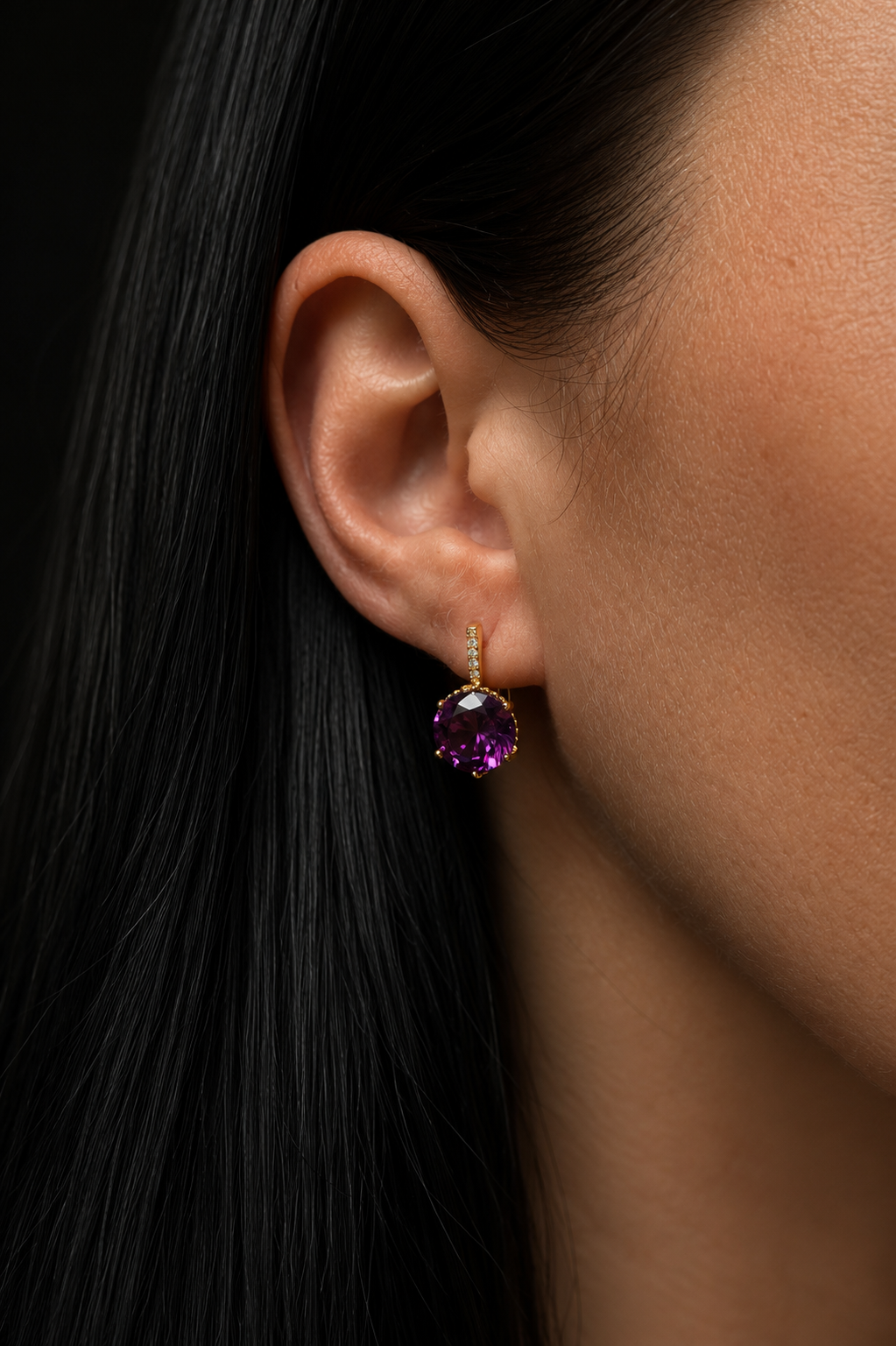 Amelia anti-allergic earrings with purple zirconia in the model's ear