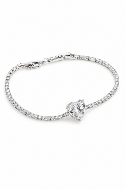 Silver-plated bracelet with a heart-shaped crystal on a white background