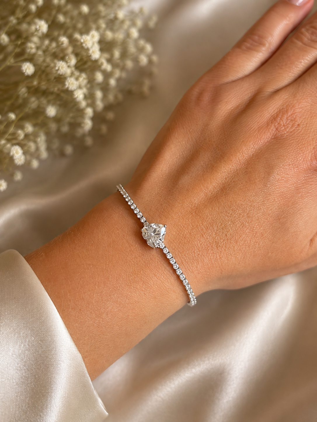 Silver-plated bracelet with a heart-shaped crystal on the hand