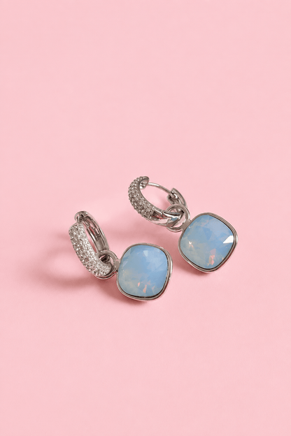 Silver-plated 2in1 earrings on a pink background