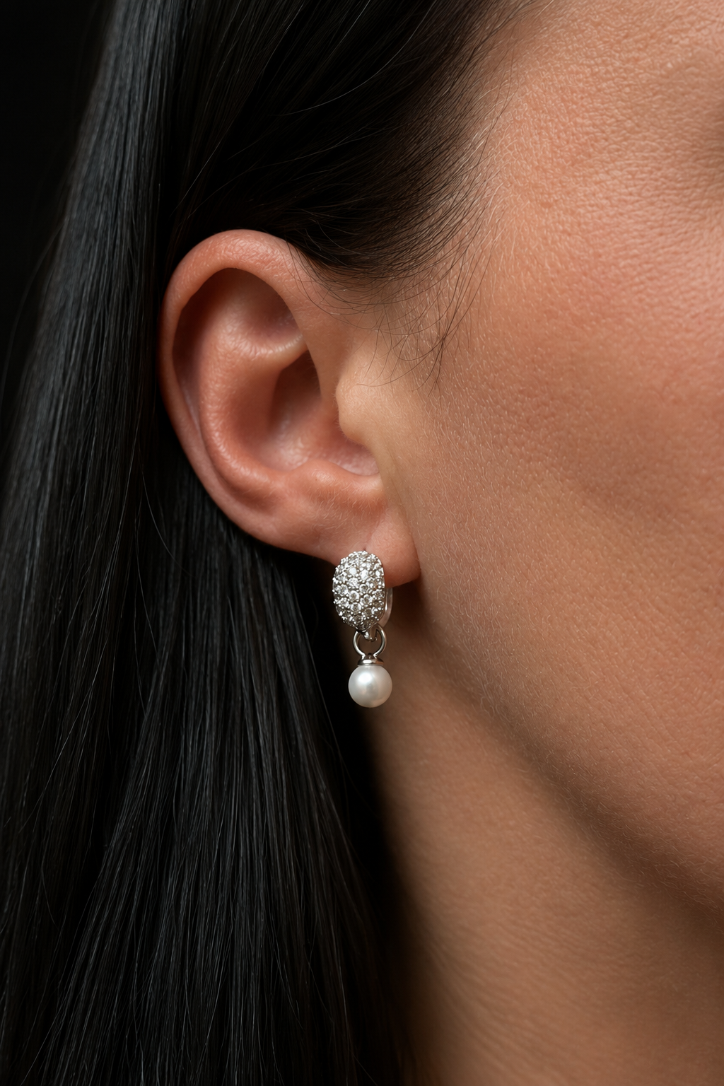 Close-up of silver-plated hoop earrings with removable pearl