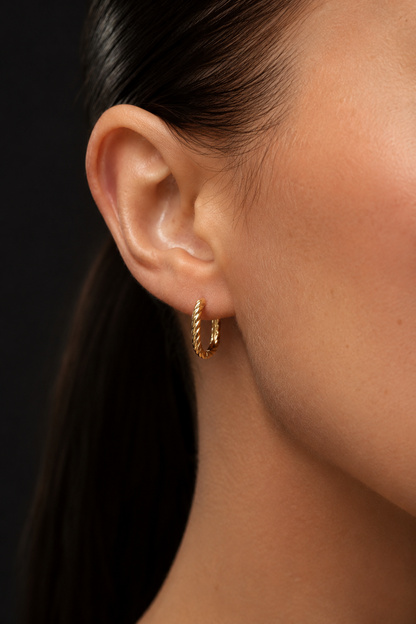 18k gold-plated twisted design oval hoop earrings on the ear