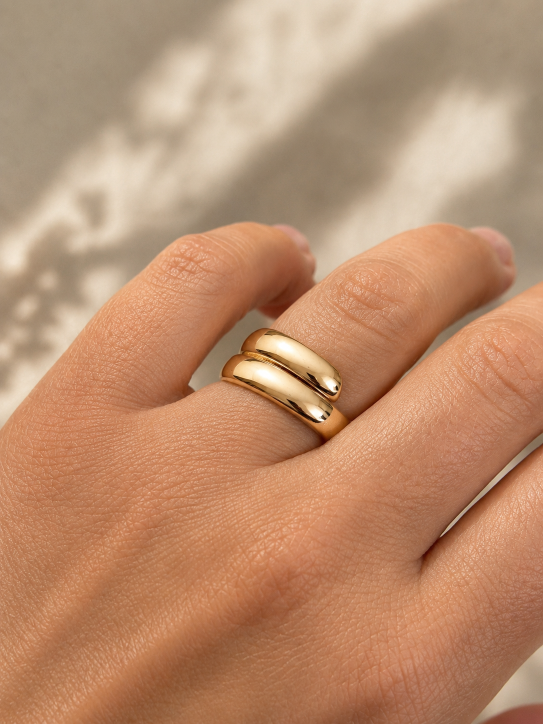 Gold plated wide open design ring on hand