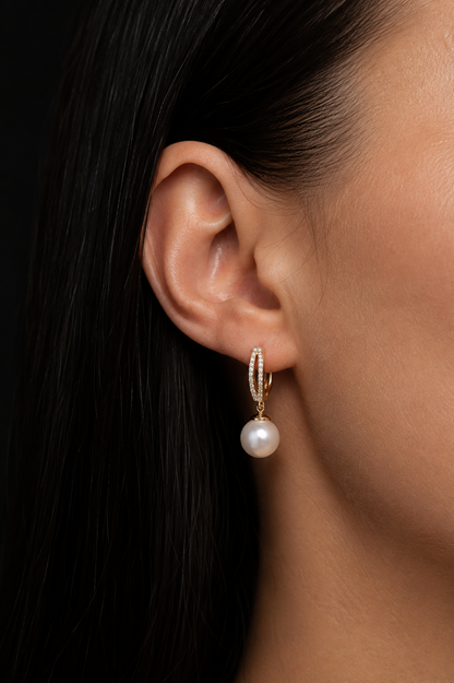 Gold-plated earrings with an English clasp and a pearl in the ear
