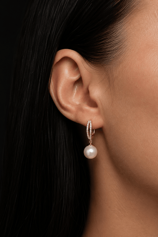 Gold-plated earrings with an English clasp and a pearl in the ear
