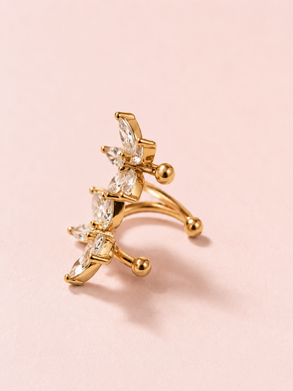 Side view of gold-plated ear cuff with floral motifs and clear cubic zirconias