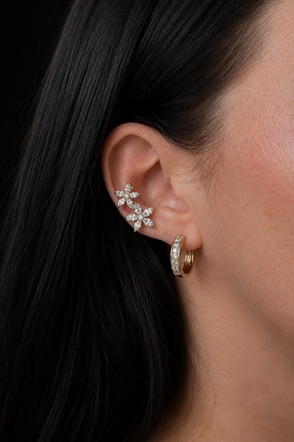 Gold-plated ear cuff with two flowers on the ear, combined with a hoop earring