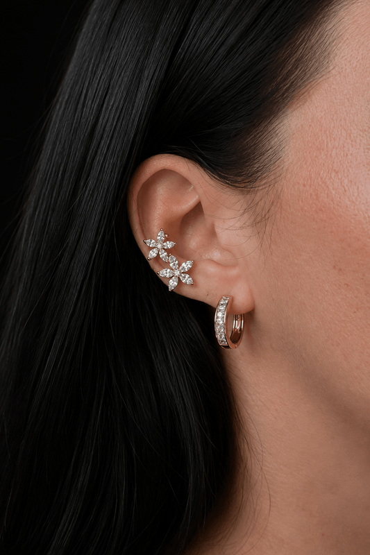 Gold-plated ear cuff with two flowers on the ear, combined with a hoop earring