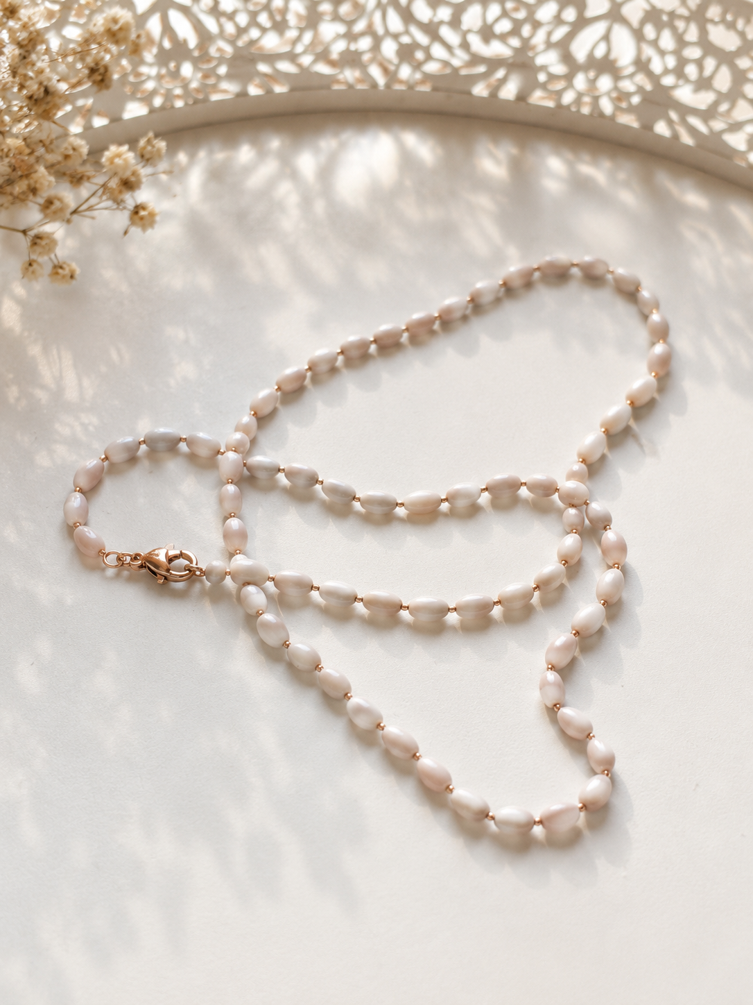 White pearl necklace 45 cm on a light background