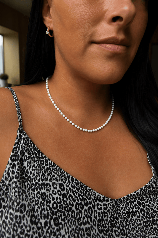 White pearl necklace on the model