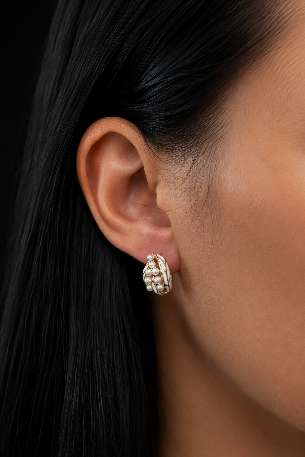 Gold-plated Elora pearl earrings worn on the ear