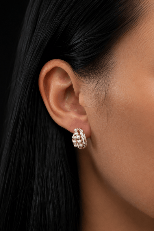 Gold-plated Elora pearl earrings worn on the ear