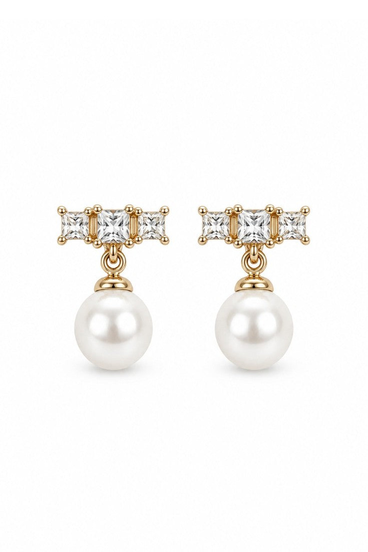 Clara stud earrings with a pearl on the model's ear