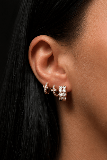 Mini hoop earrings with a zirconia cross in the ear and in the hole next to it