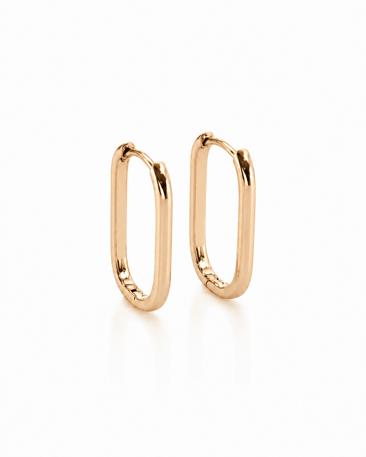 Monika – 18k gold-plated oval hoop earrings on a white background
