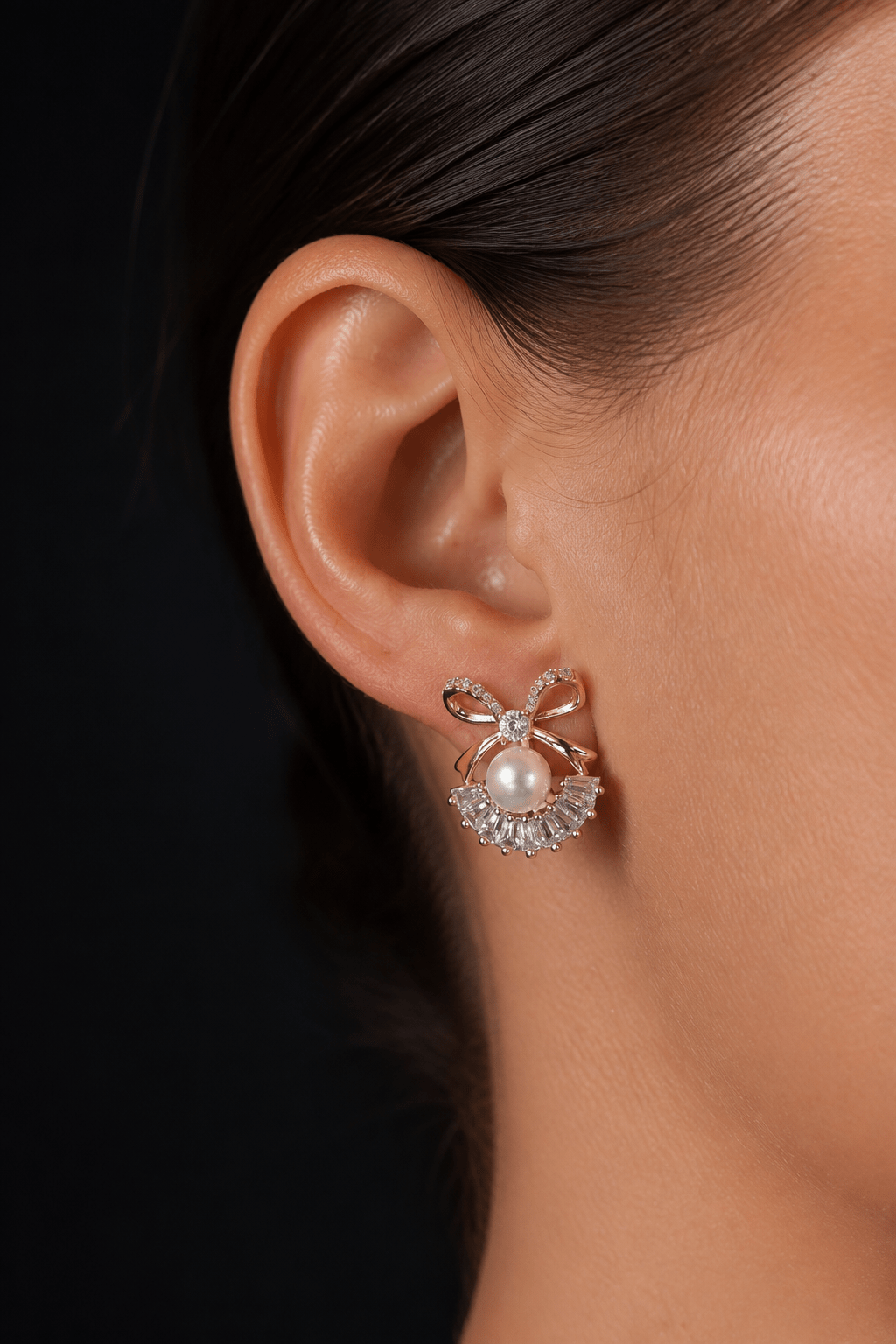 Stud earrings with pearls on the ear