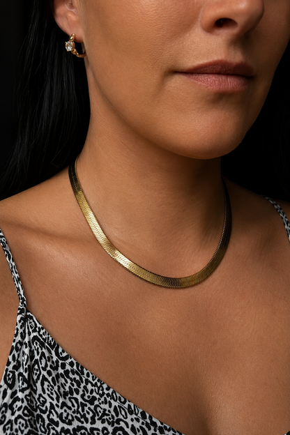 Wide gold plated flat necklace on model