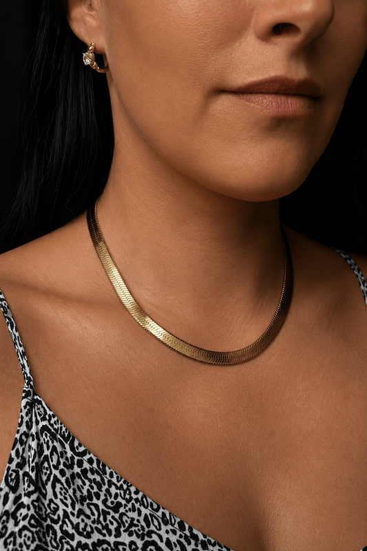 Wide gold plated flat necklace on model