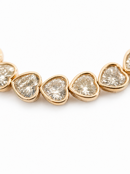 Close-up of a gold-plated bracelet with crystal hearts