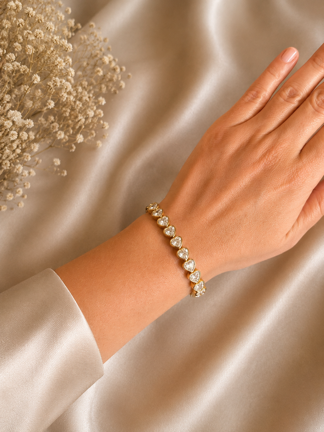 Gold-plated bracelet with crystal hearts on the arm