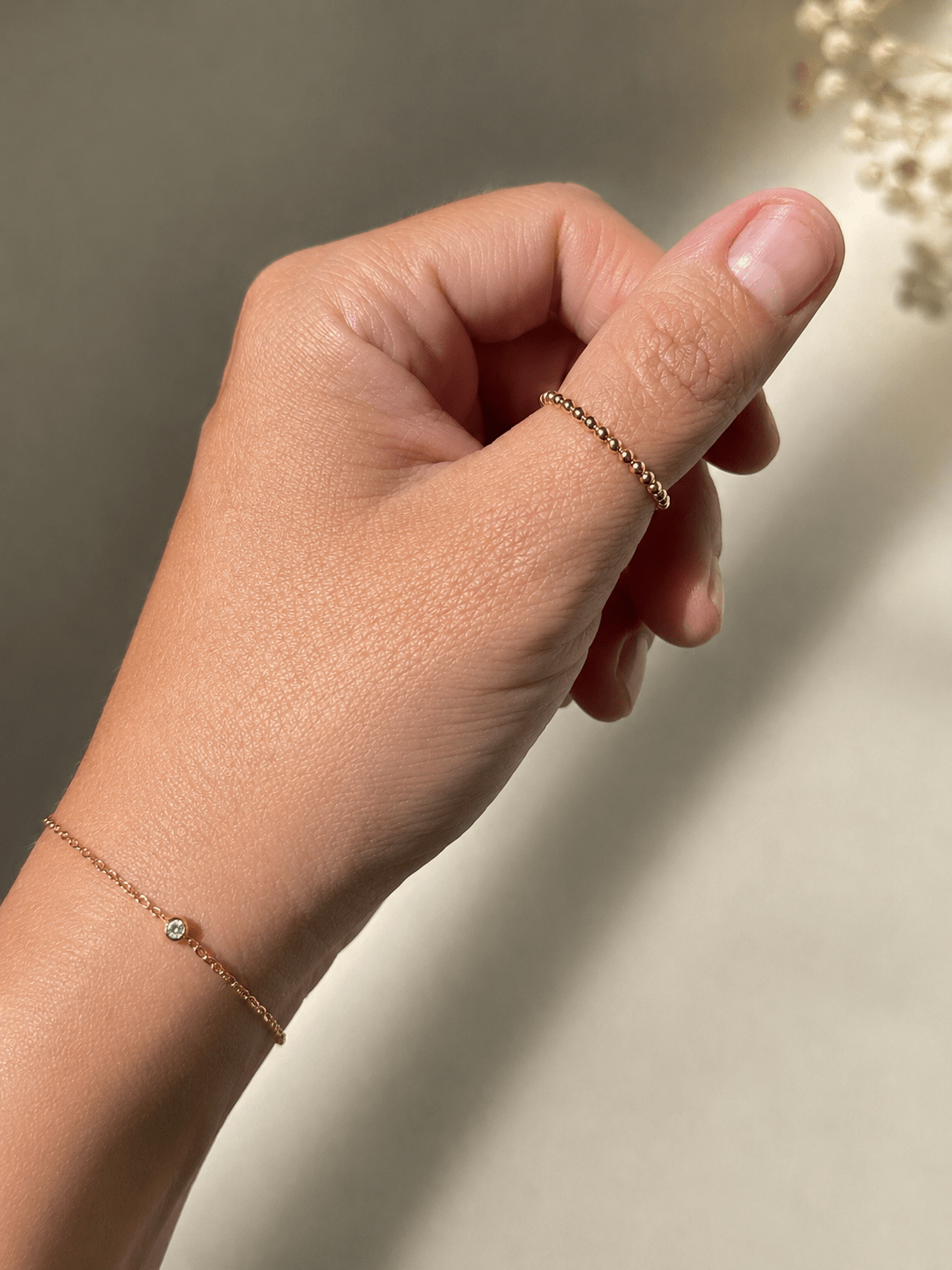 Fine gold-plated ball ring on hand