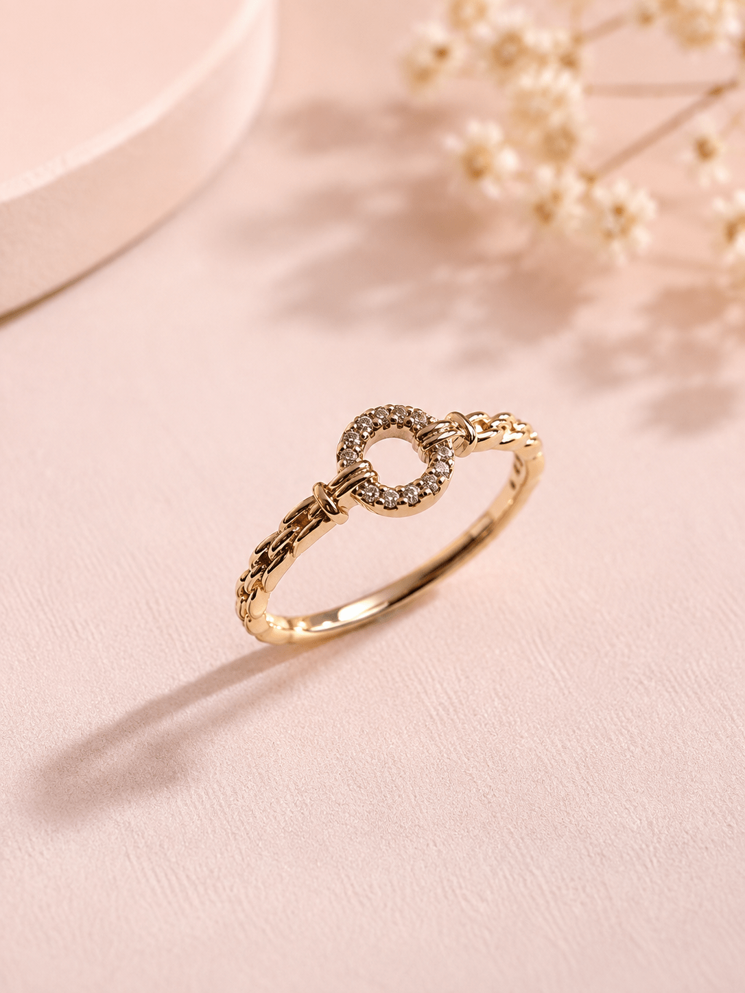 Fine gold-plated ring with zircons in a circle design, studio photo