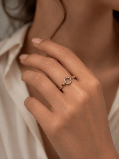 A delicate gold-plated ring with a zirconia ring on the hand